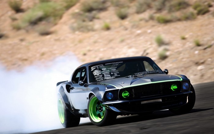 Drifting Ford Mustang with green accents and smoke