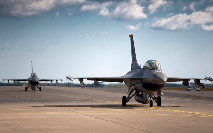 Two F-16 fighter jets on a runway