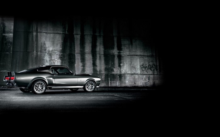 Shelby GT500 Super Snake parked by concrete wall