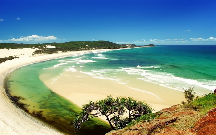 Scenic beach with turquoise water and green hills