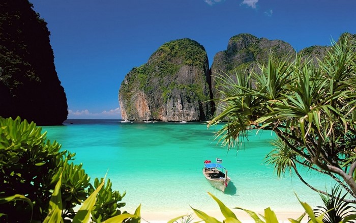 Tropical bay with limestone cliffs and a boat