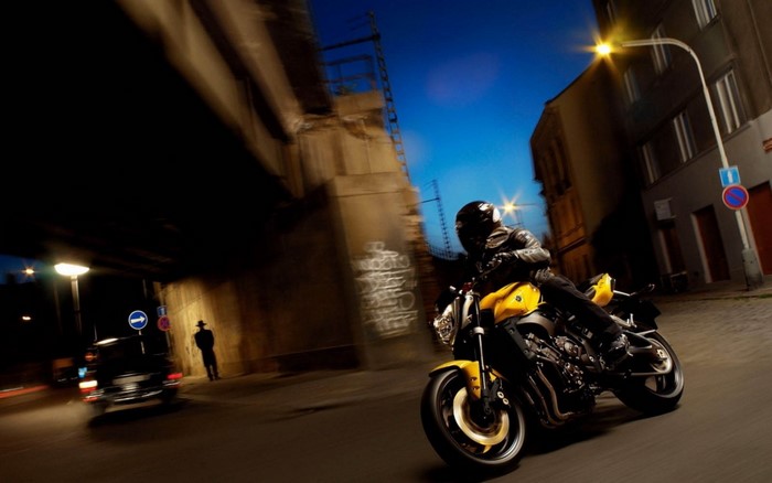 Yellow Yamaha FZ1 motorcycle with rider at night