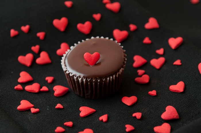 Chocolate cupcake with red heart sprinkles