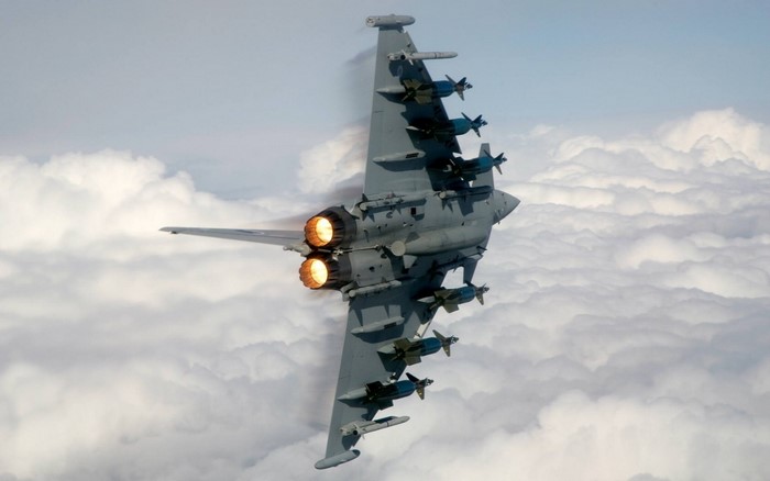 Eurofighter Typhoon fighter jet flying above clouds