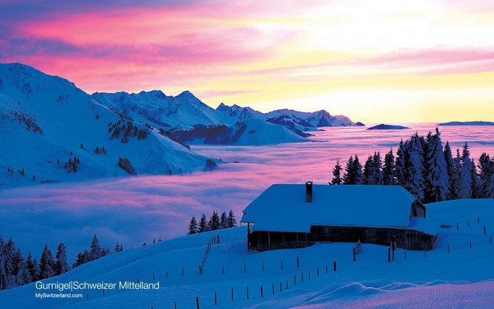 Winter mountain landscape with a cabin at sunset