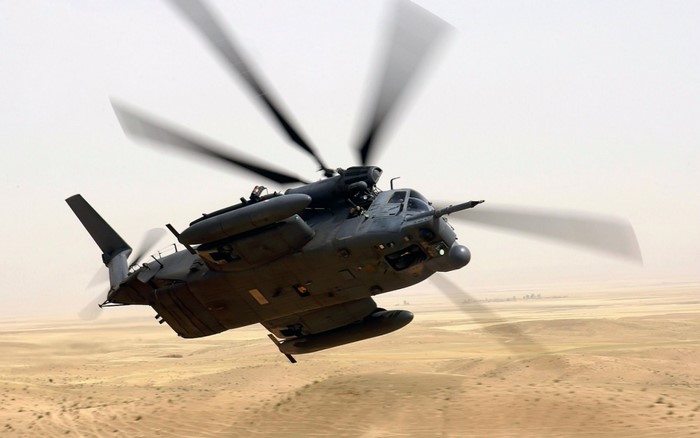 MH-53 Pave Low helicopter flying over desert