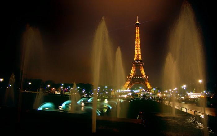 Eiffel Tower at night with fountains in Paris