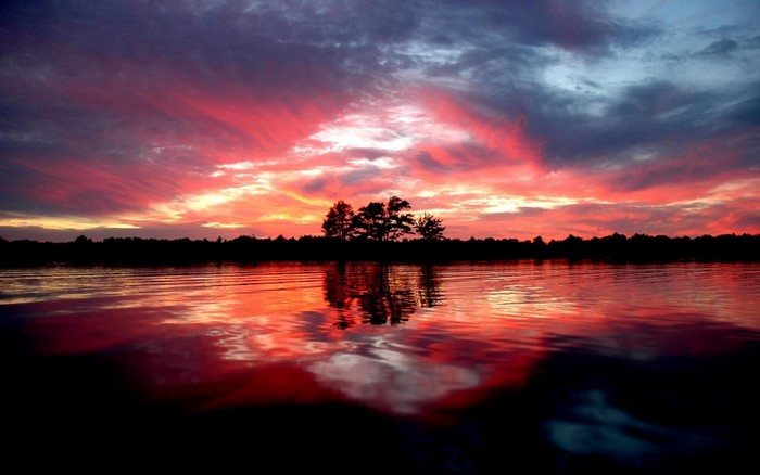 Sunset over a lake with colorful clouds and reflections