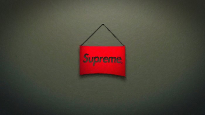 Red Supreme logo sign hanging on a wall