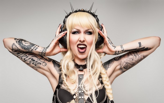 Woman with headphones and tattoos