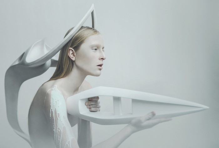 Model with futuristic headpiece and object
