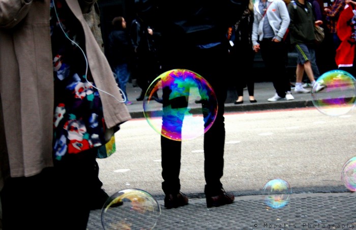 People blowing colorful bubbles at an outdoor event