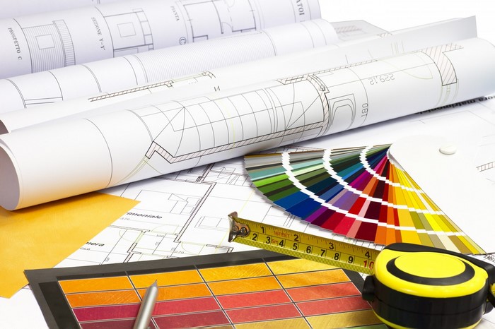 Architectural blueprints, color swatches, and measuring tape