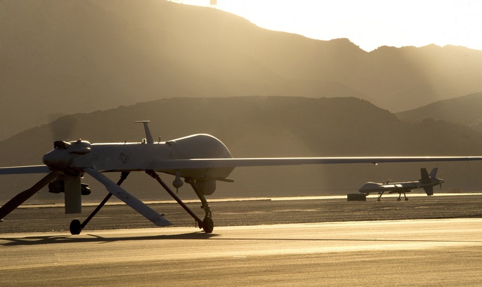 MQ-9 Reaper drones on tarmac at sunset