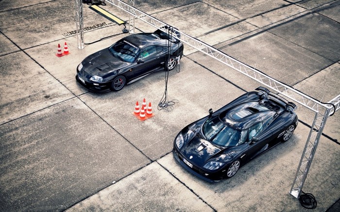Two black sports cars, Toyota Supra and Koenigsegg