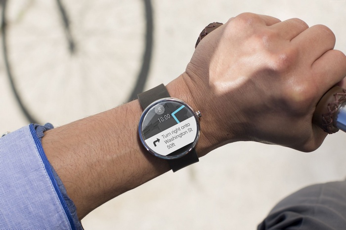Person wearing Android Wear smartwatch with navigation