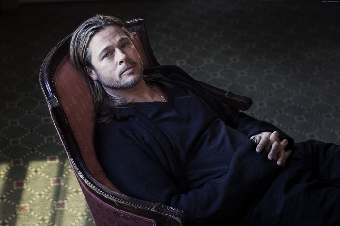 Brad Pitt sitting in a chair