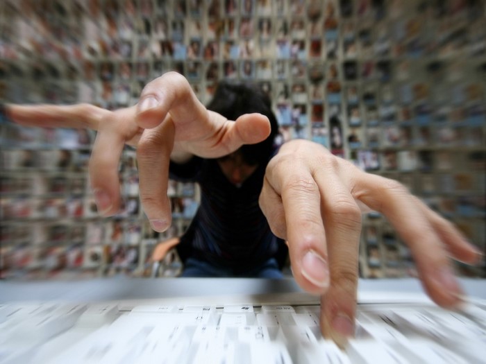 Person typing on a keyboard with hands in focus