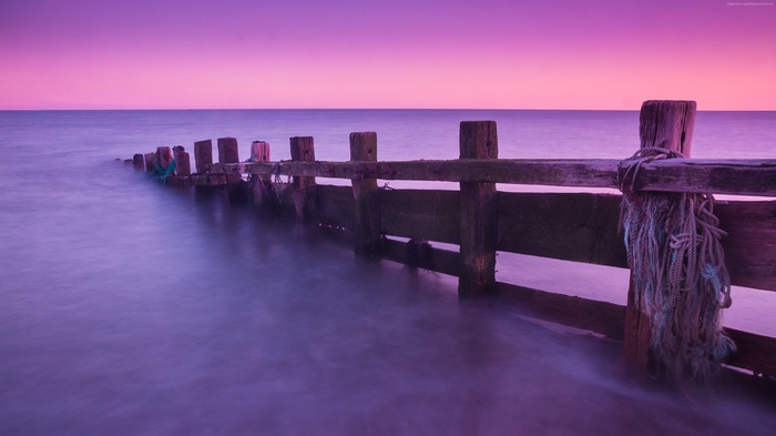 Wooden pier at sunrise over the sea