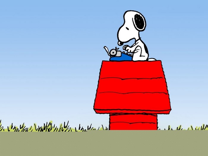 Snoopy from Peanuts writing on a typewriter