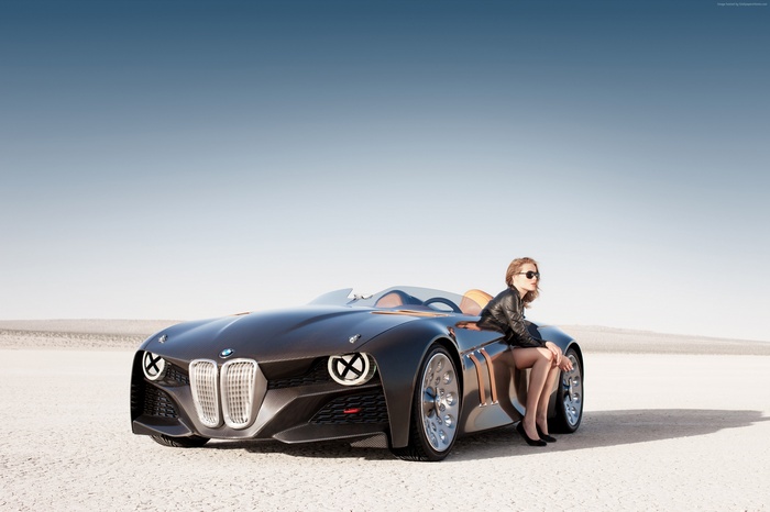 Woman in leather jacket sitting on a BMW Hommage concept car
