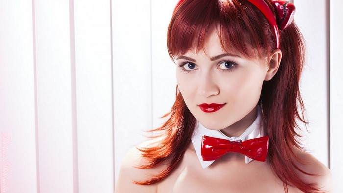 Redhead woman with blue eyes and red bow tie