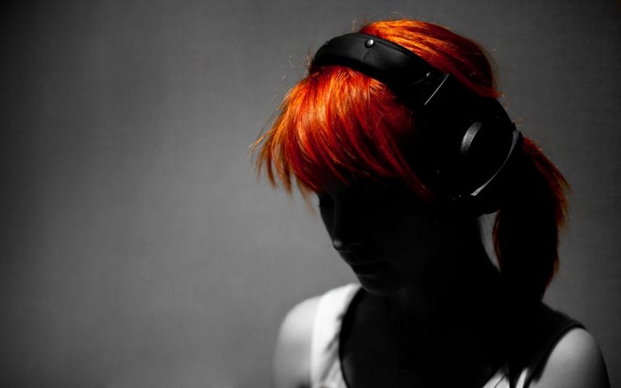 Woman with red hair and headphones
