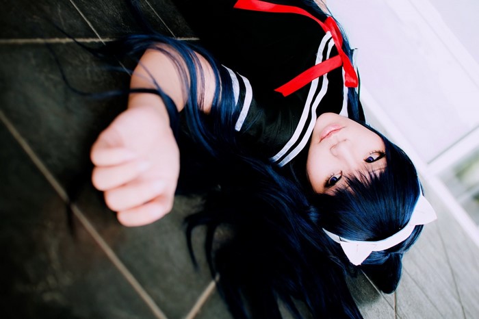 Woman in black anime cosplay costume lying down