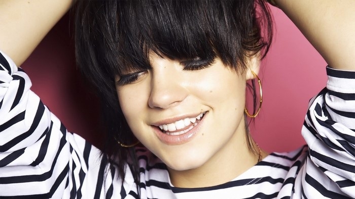 Lily Allen smiling with hands in hair
