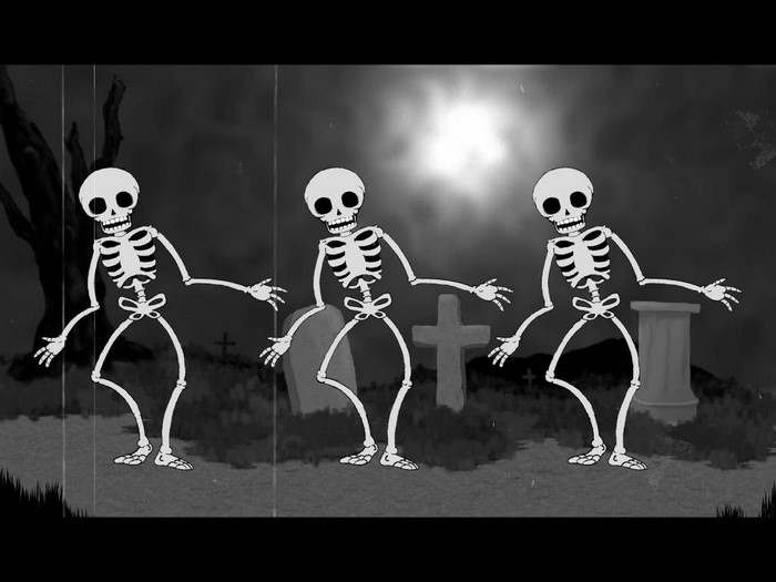 Dancing skeletons in a graveyard at night
