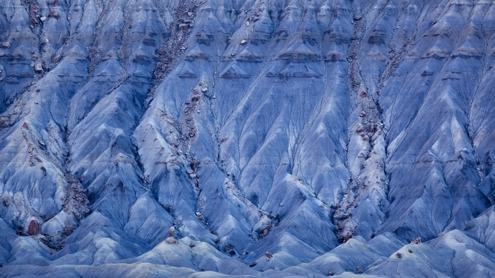 Blue desert badlands with eroded hills