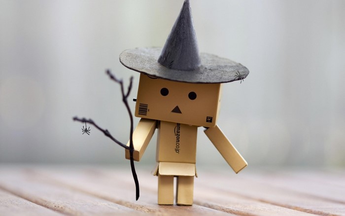Danbo dressed as a witch with spiders and twigs