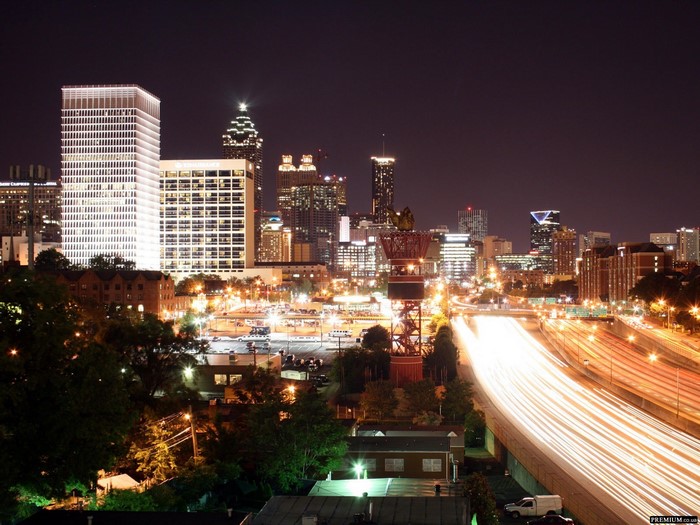 Atlanta cityscape at night with light trails on highway
