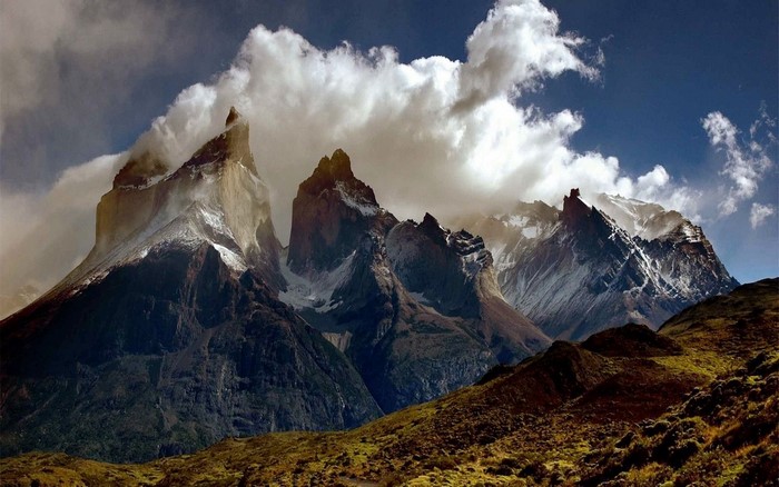 Jagged mountains with clouds and a valley