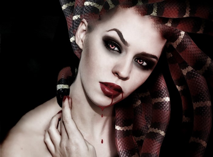 Woman with snakes on head and blood dripping from lips