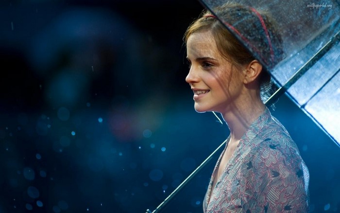Emma Watson under an umbrella in the rain