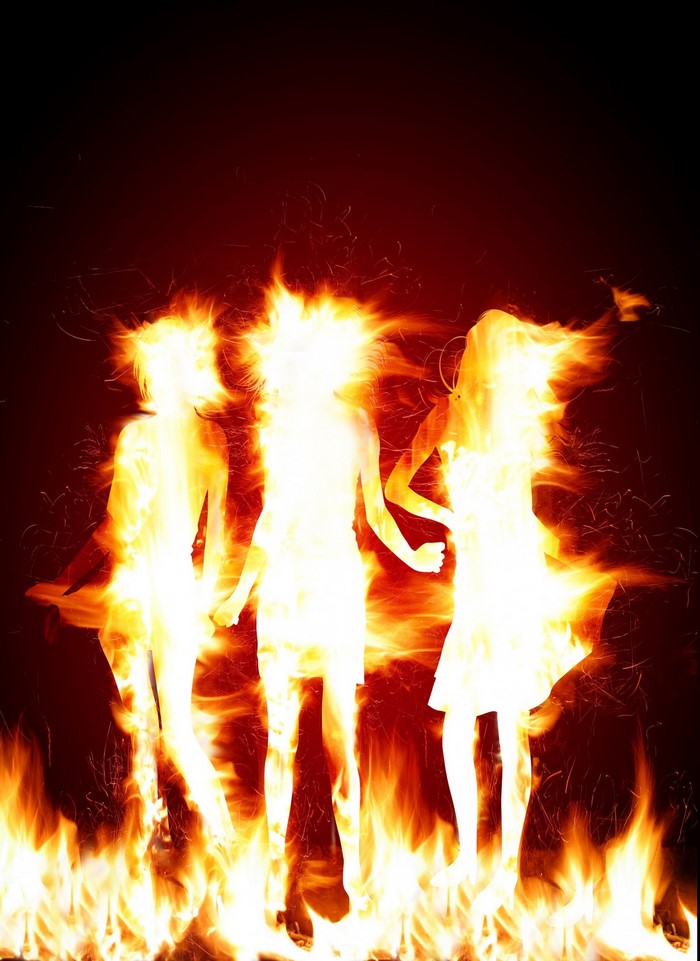 Three figures engulfed in flames