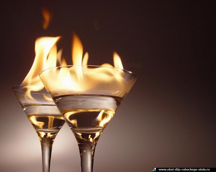 Two flaming cocktails in martini glasses
