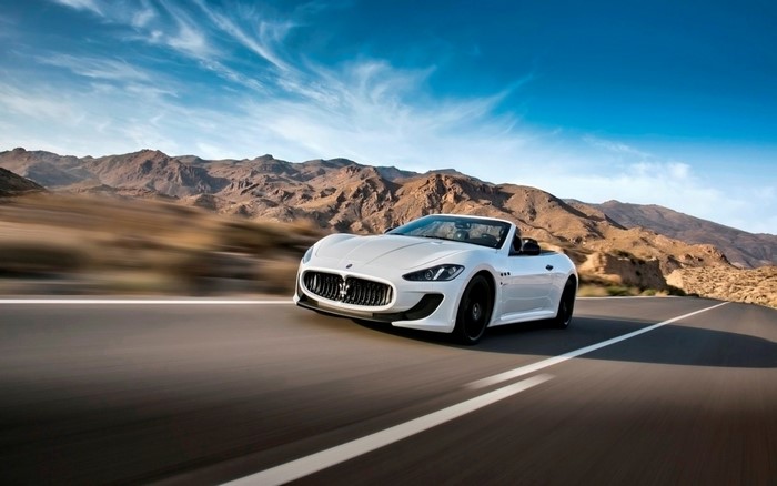 White Maserati Gran Cabrio MC driving on a desert road