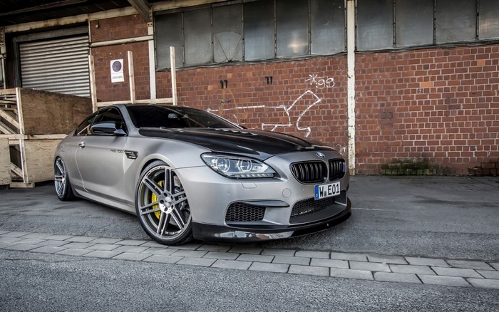 Manhart BMW MH6 700 parked in front of a brick building