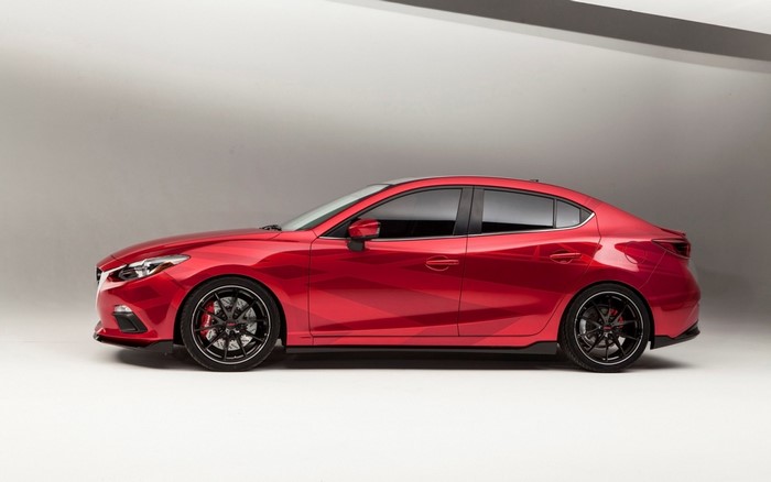 Red Mazda 3 Sedan with custom wheels