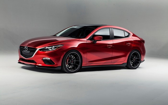 Red Mazda 3 Sedan with custom wheels