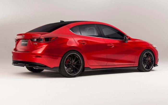 Red Mazda 3 Sedan with custom wheels