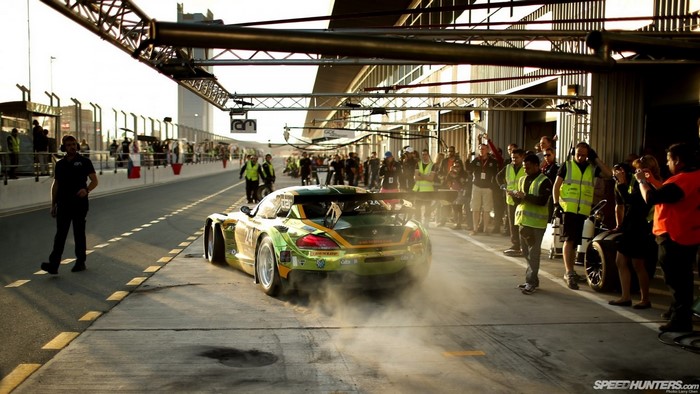 Race car in pit lane with crew