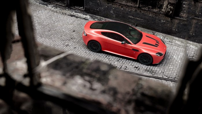 Red Aston Martin Vantage parked on cobblestone street
