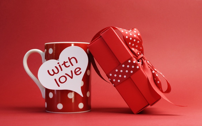 Red mug with white polka dots and a gift box