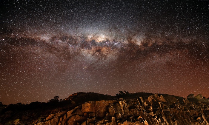 Milky Way over rocky mountains at night