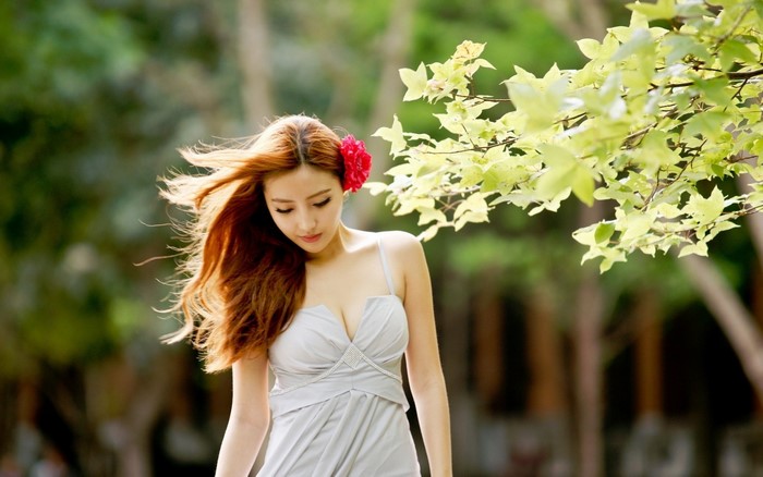 Woman with long hair and flower in dress