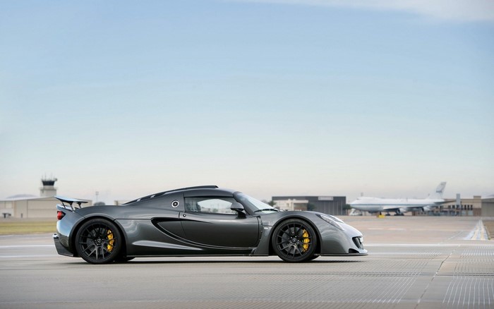 Hennessey Venom GT on an airport tarmac with a jetliner