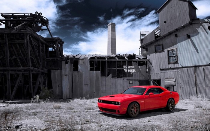 Red Dodge Challenger SRT in abandoned industrial setting